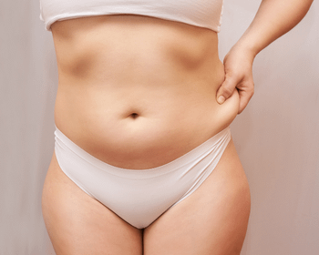 woman pinching abdominal fat