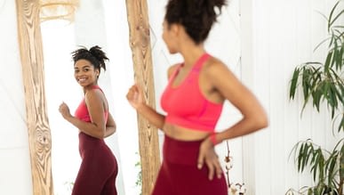 fit woman in front of mirror