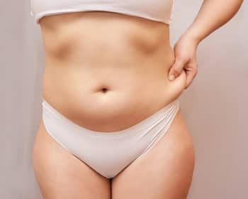 woman pinching abdominal fat