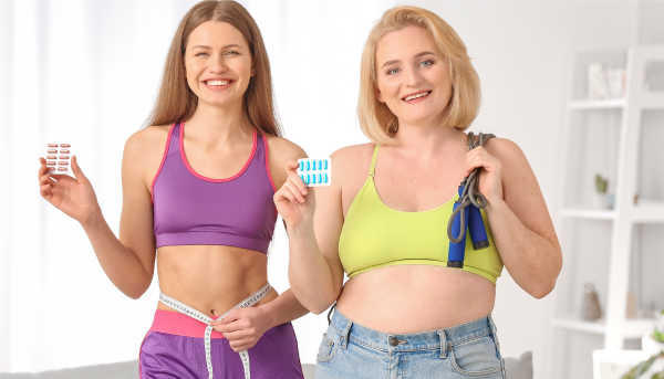 2 women holding weight loss pills